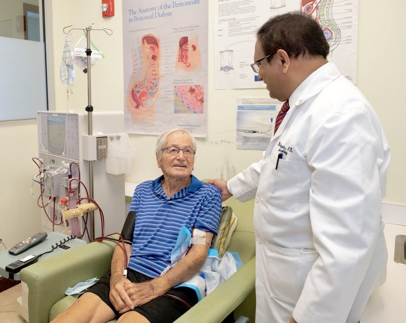 Dr. Bharat K. Gupta, MD consulting with a patient during dialysis treatment at Crown Dialysis Center