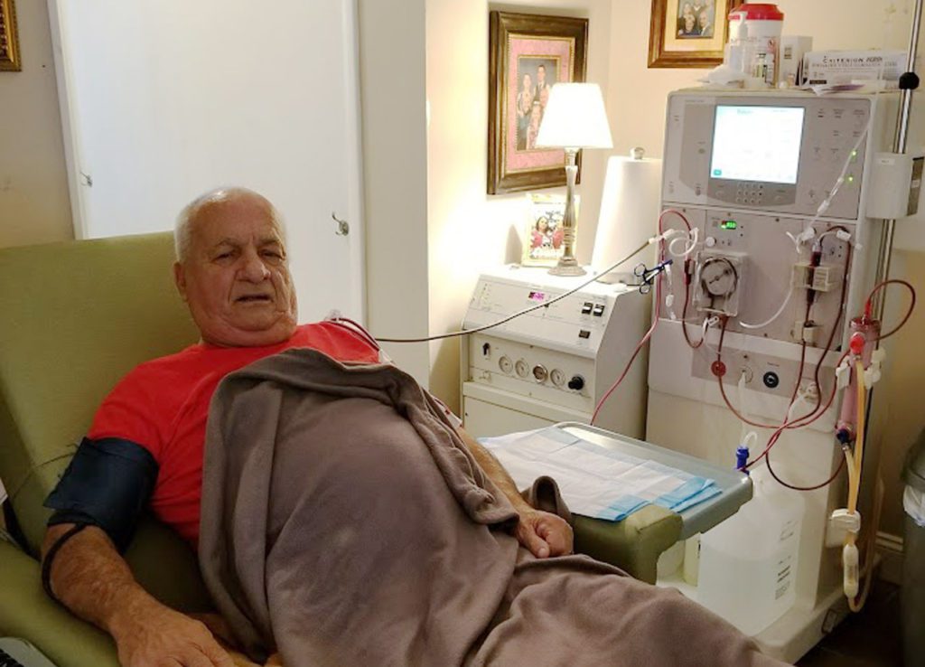 Patient receiving staff-assisted home hemodialysis in the comfort of their home